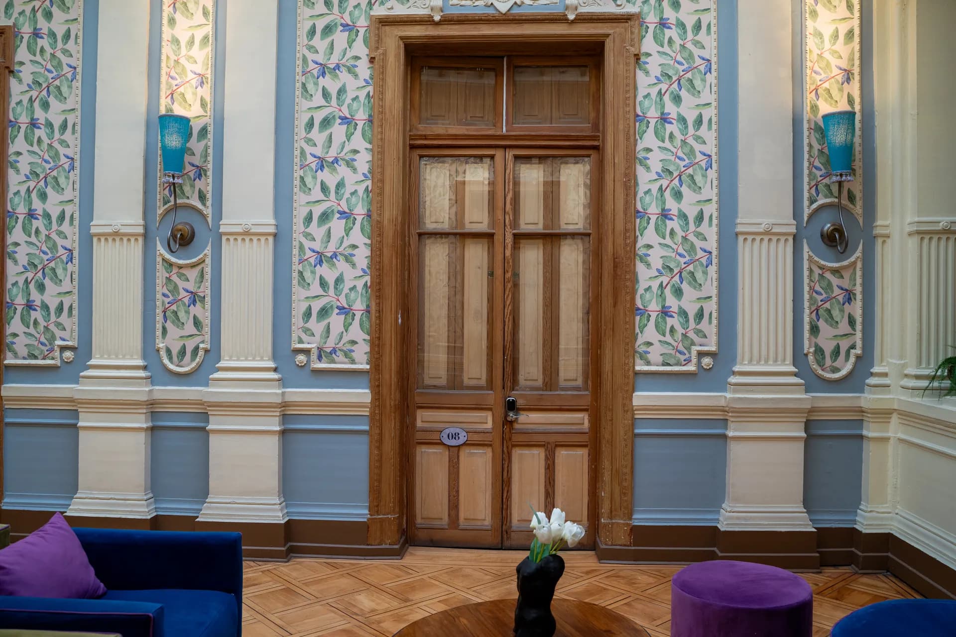 Happy House grand entrance hall with original parquet floors, decorative moldings and heritage architectural details in Santiago Centro