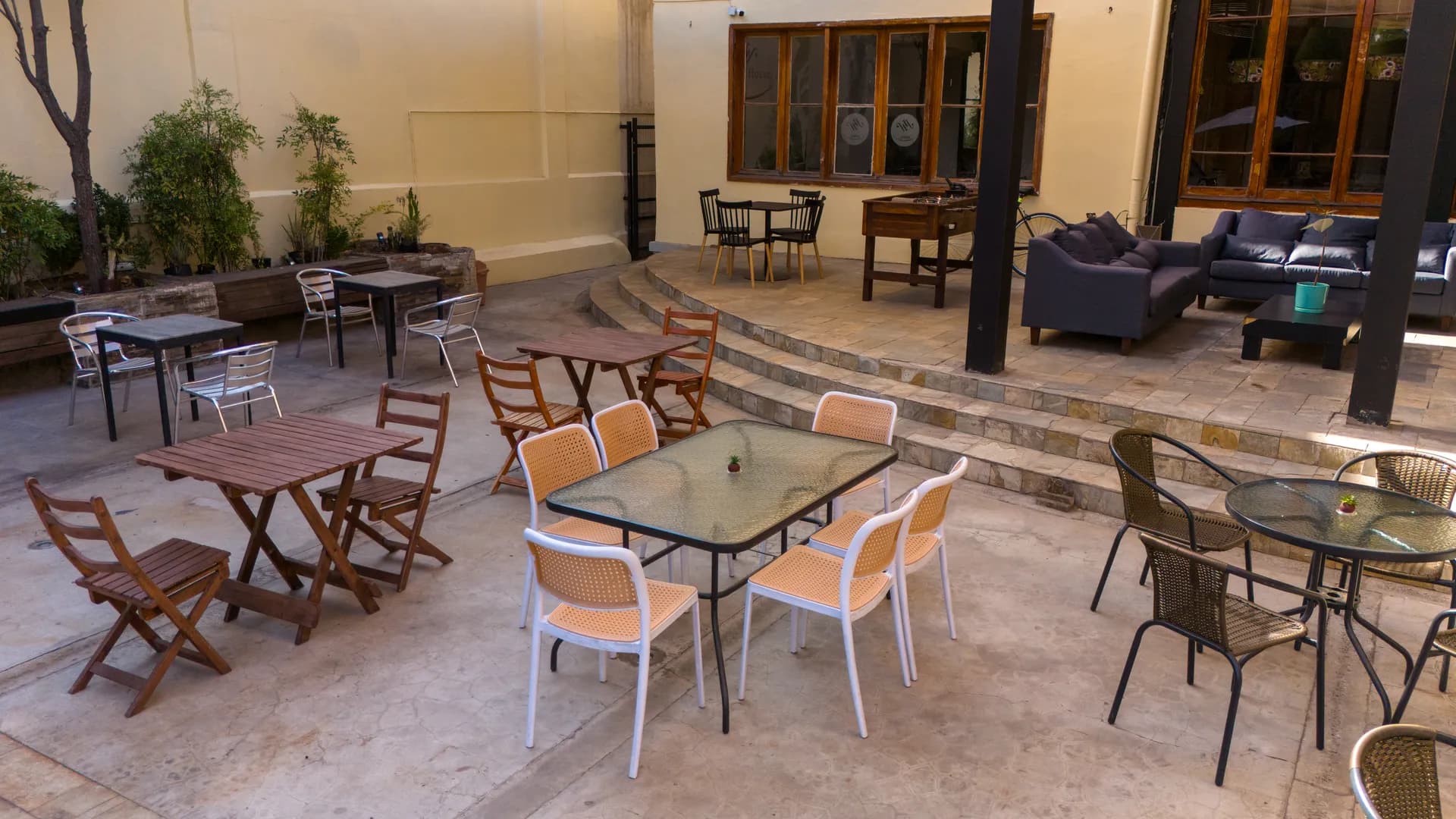 Happy House garden patio and social area in Santiago — multi-level terrace with plants, seating and BBQ area for guests