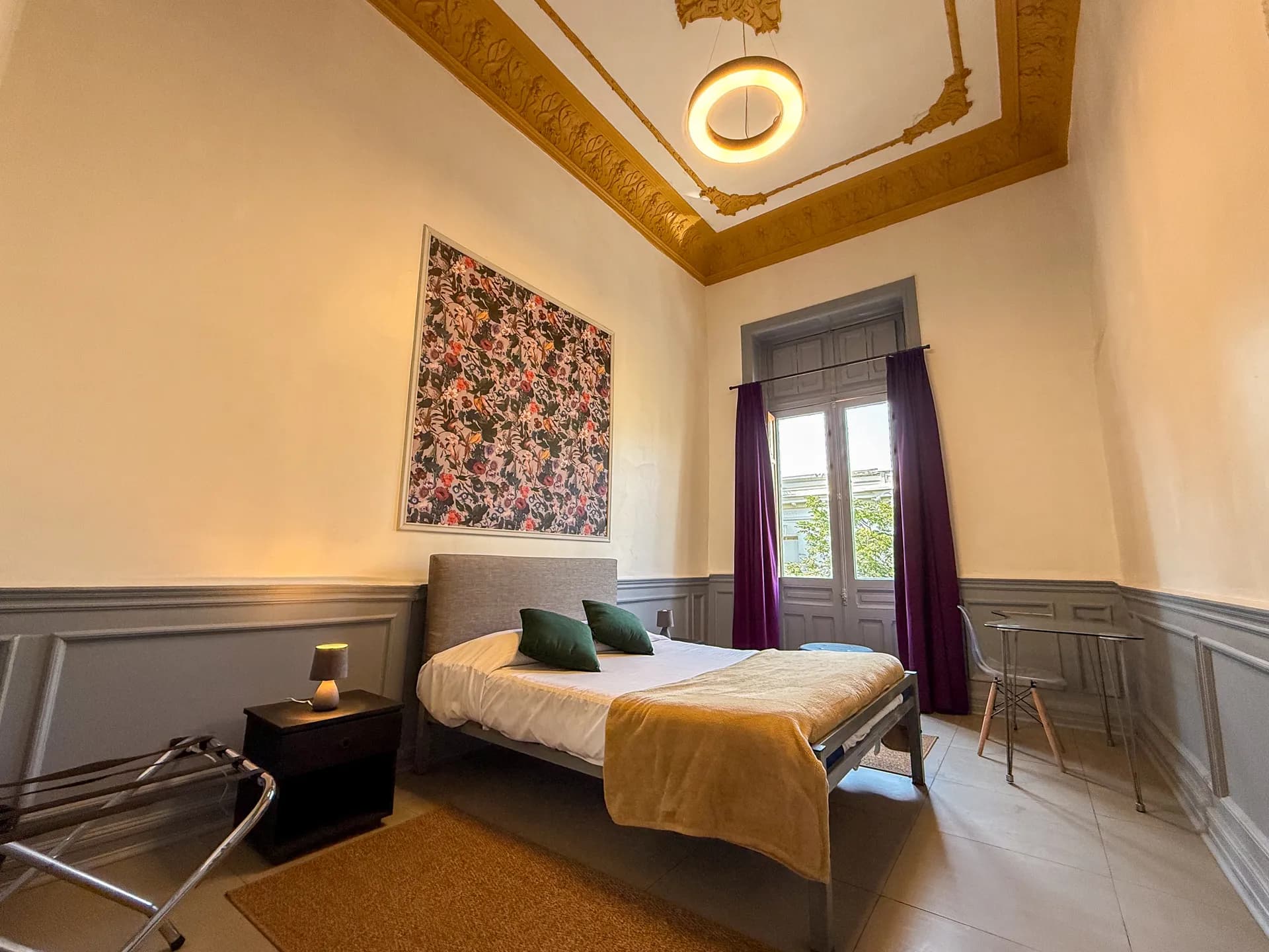 Clean and comfortable standard private room at Happy House Santiago with double bed and wooden floors